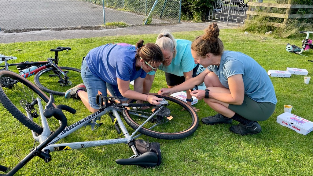 three women fixing a bike
